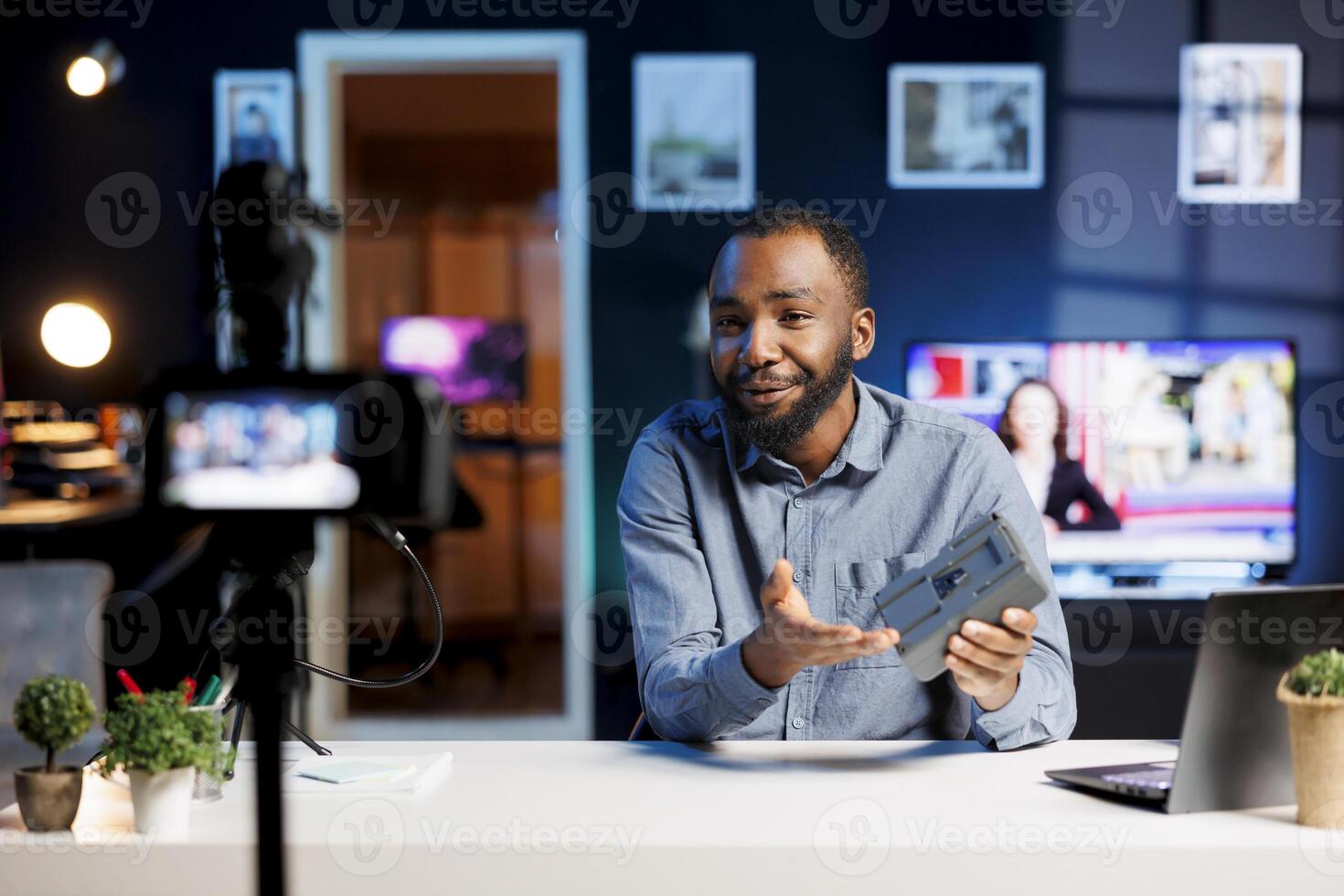 Content creator filming tech tutorial on how to do camera systems V mount battery maintenance. Man providing viewers with guide to keep portable lithium accumulator running smoothly photo