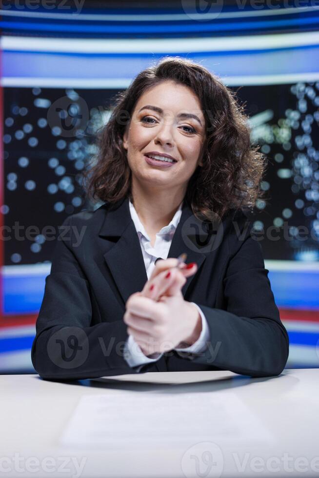 News reporter on midnight talk show going live on television channel broadcast, covering daily events and breaking news in studio. Journalist presenter reporting information on global tv network. photo