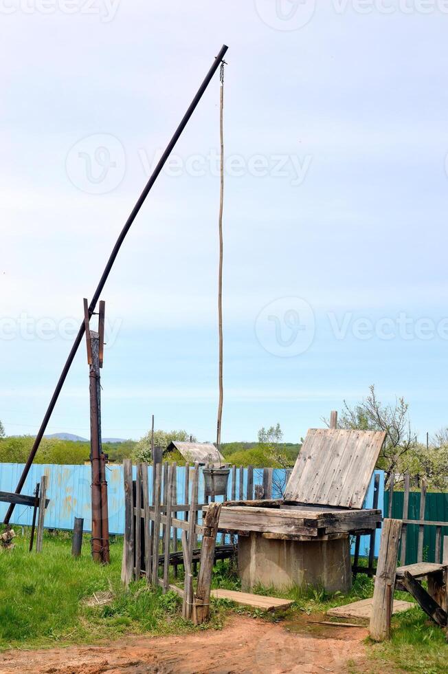Unique old Russian well named shadoof or shaduf in countryside on a summer day photo