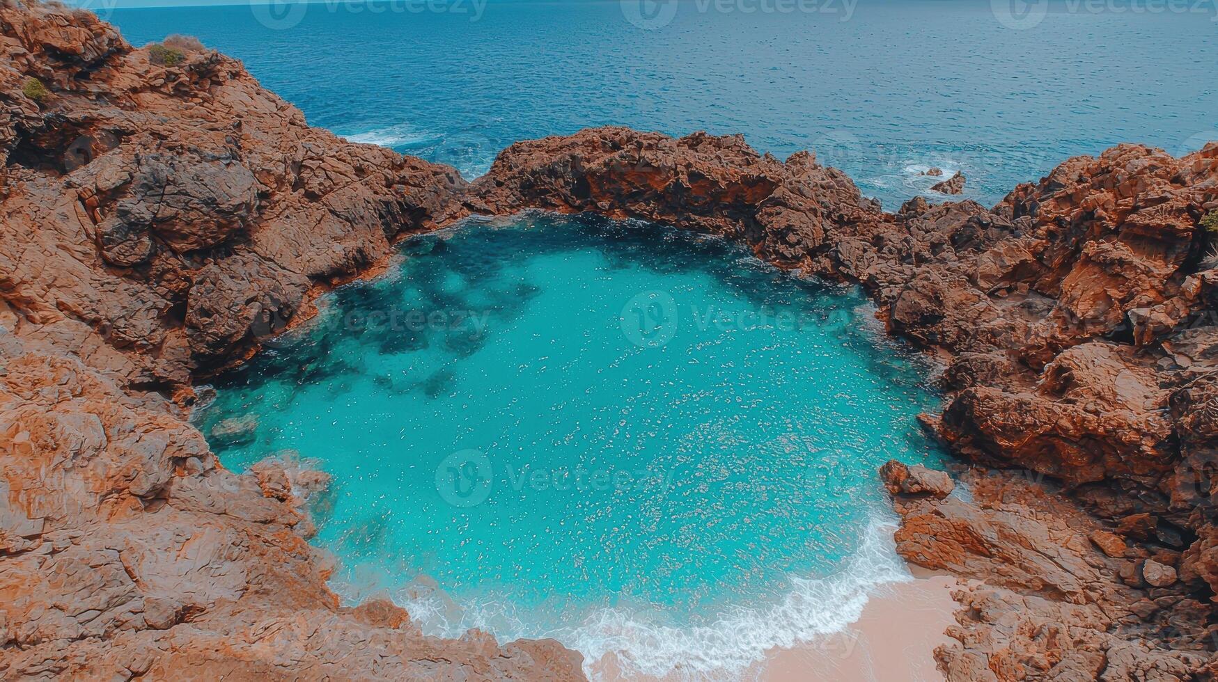 Secluded turquoise cove nestled between dramatic red rocks photo