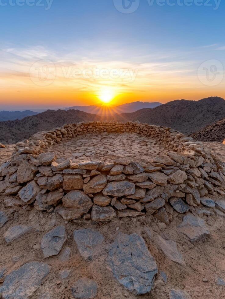 Sunset over mountain range viewed from stone circle photo