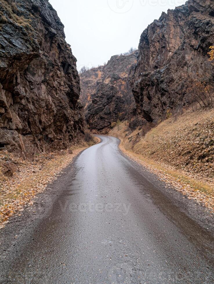 Scenic winding road through autumnal mountain pass photo