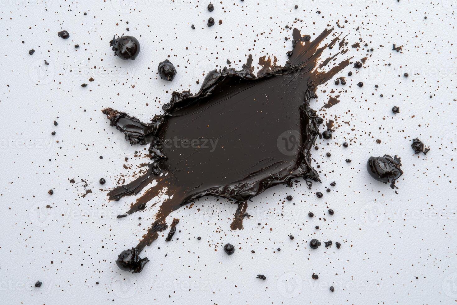 Dark brown paint splatters on white background photo