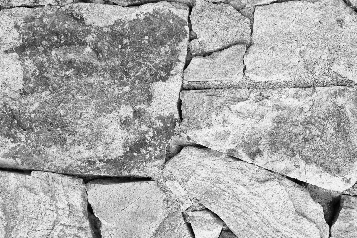 A black and white photo of a stone wall