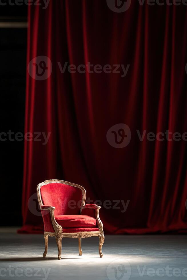 The spotlight shines on an ornate red chair set against lush red velvet curtains on a proscenium stage, showcasing an elegant Old World ambiance in warm lighting photo