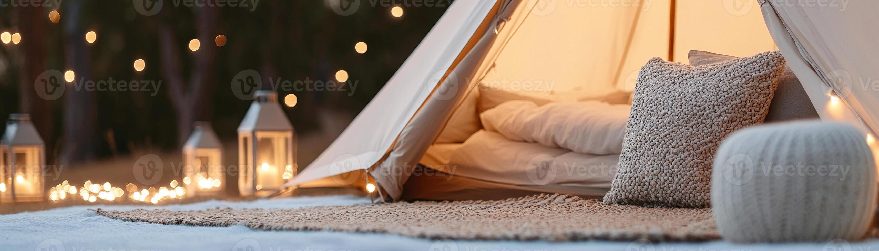 Enjoy an upscale outdoor experience with luxury tents featuring plush bedding, stylish rugs, and enchanting fairy lights, all nestled among softly lit trees and lanterns photo