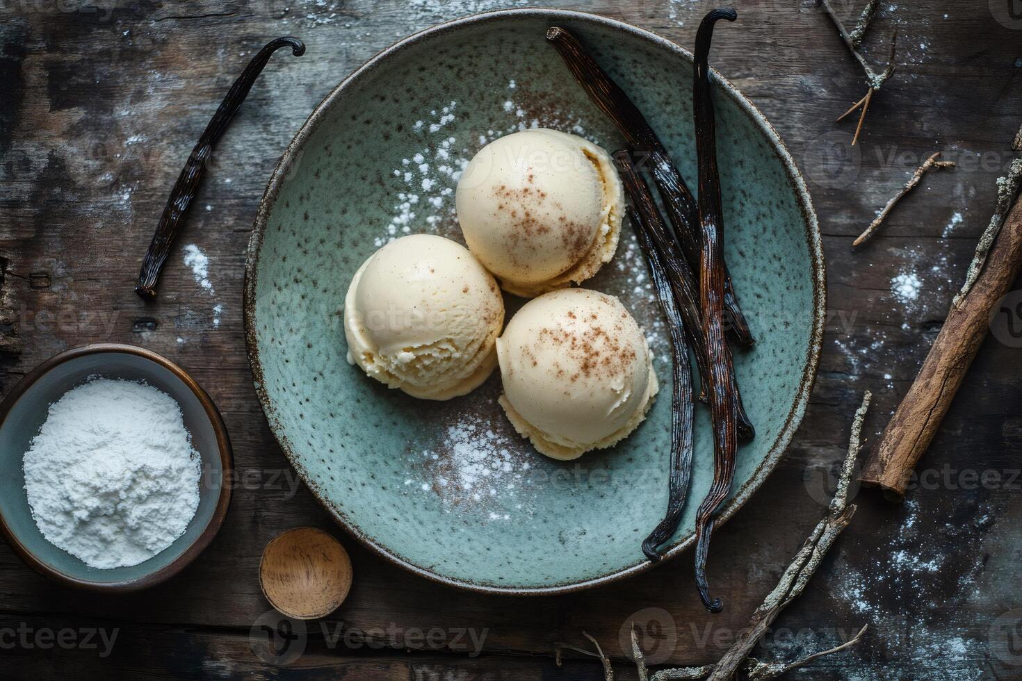 Vanilla ice cream scoops with vanilla pods and powdered sugar on rustic wooden table photo