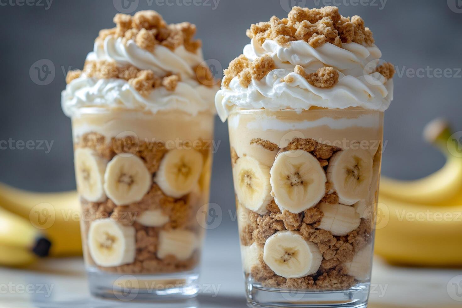 Banana Pudding Dessert Parfaits Layered with Whipped Cream and Cookie Crumbles photo