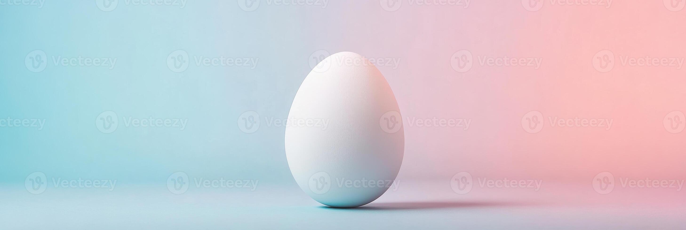 Minimalist white egg against colored gradient background for conceptual design photo