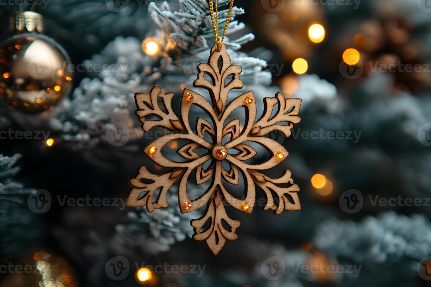 Ornate Wood Snowflake Ornament on Frosted Christmas Tree with Warm Lights photo