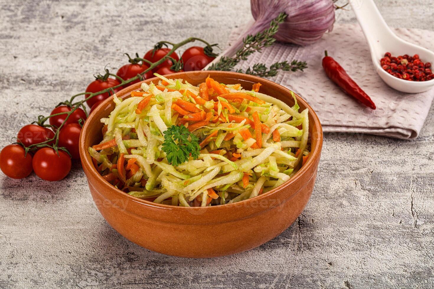 A bowl of coleslaw with carrots and tomatoes photo