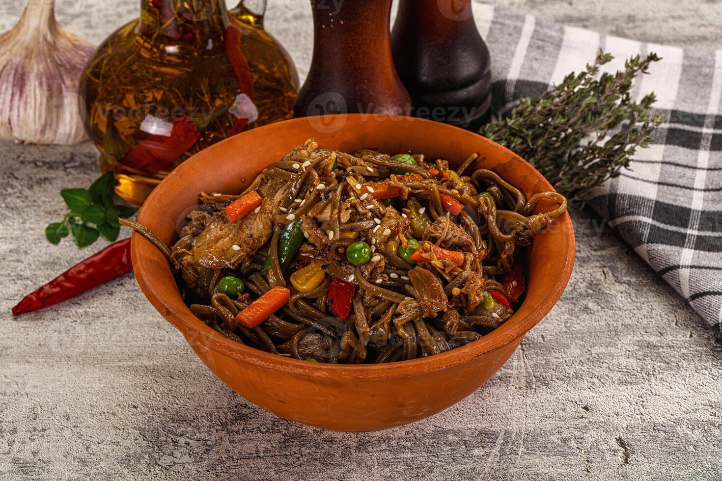 A bowl of noodles with vegetables and garlic photo