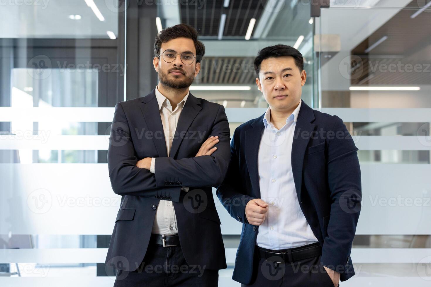 Confident professionals standing in office setting, displaying teamwork and leadership. Business attire enhances their professionalism, conveying success. photo