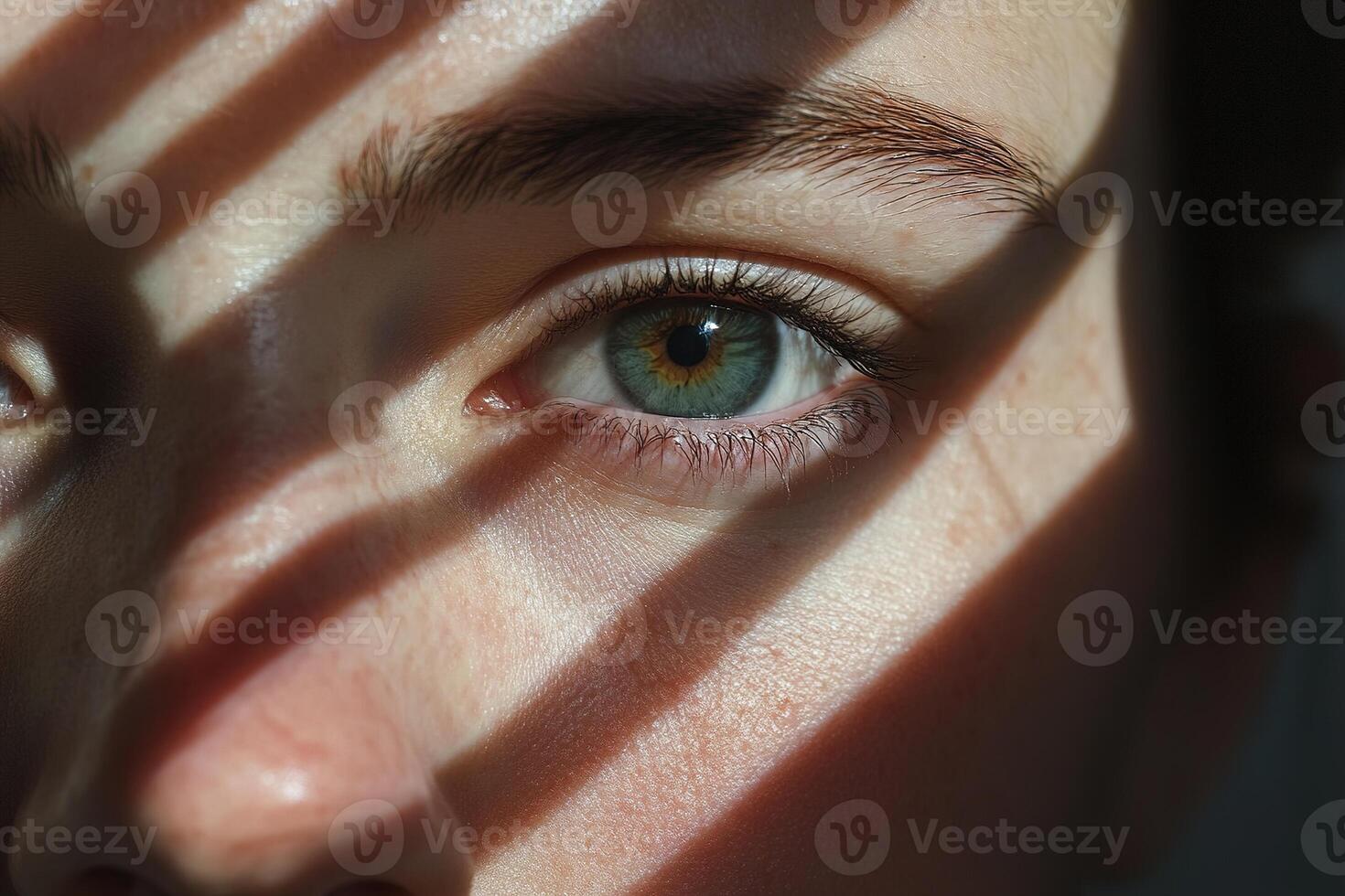 Half of the face is shrouded in deep shadows, with only one eye visible, gazing intensely at the viewer, creating a captivating and mysterious atmosphere photo