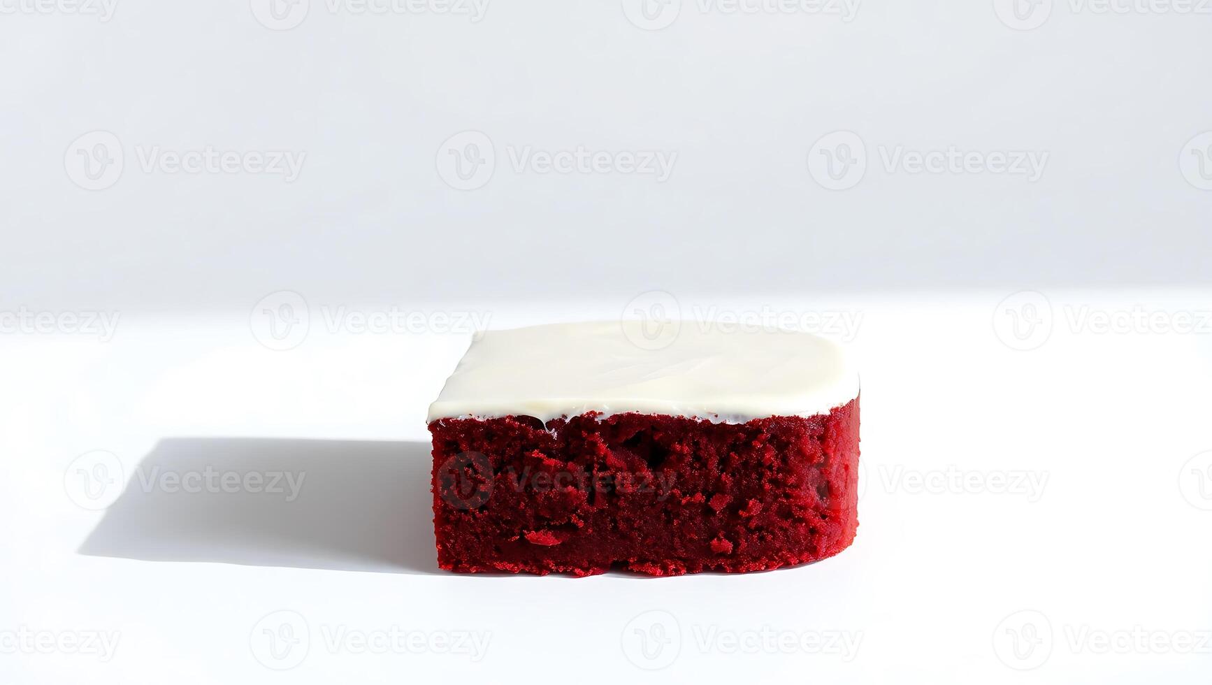 Red velvet cake slice with cream cheese frosting on a plain background photo