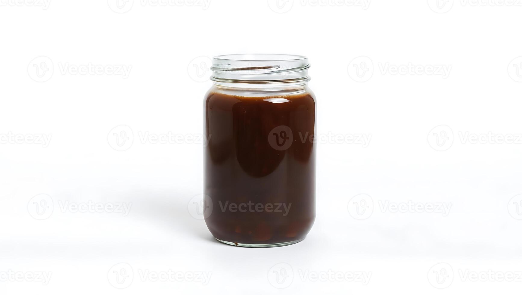 Brewed beverage in a jar with rich texture and deep hue photo
