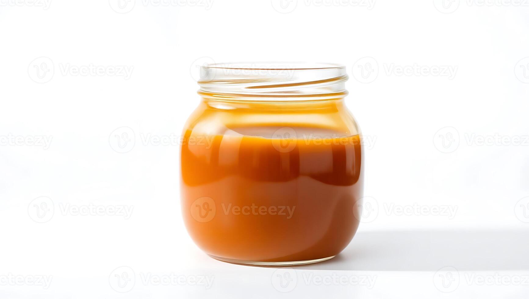 Rich caramel sauce in a clear jar ready for desserts and baking photo