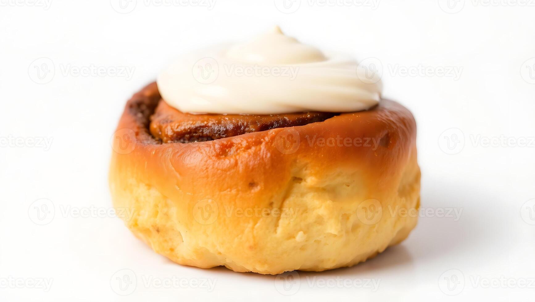 Freshly baked cinnamon roll with creamy frosting on top photo