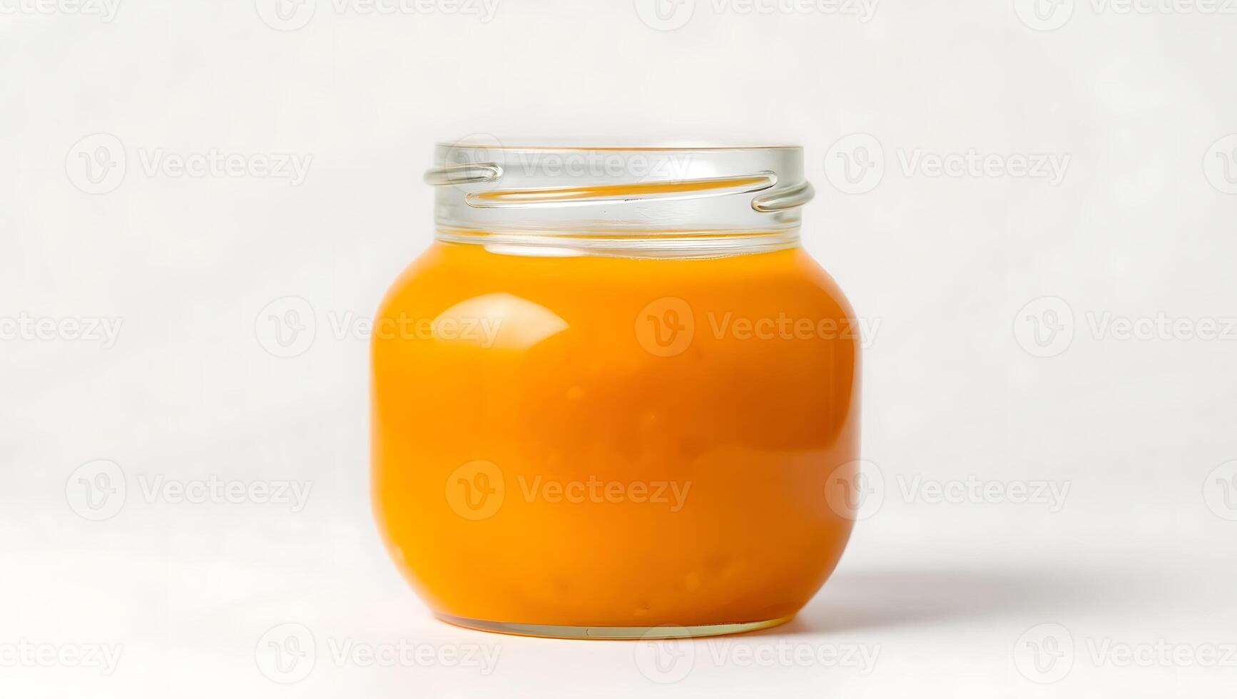 Bright orange jar filled with homemade puree on simple background photo