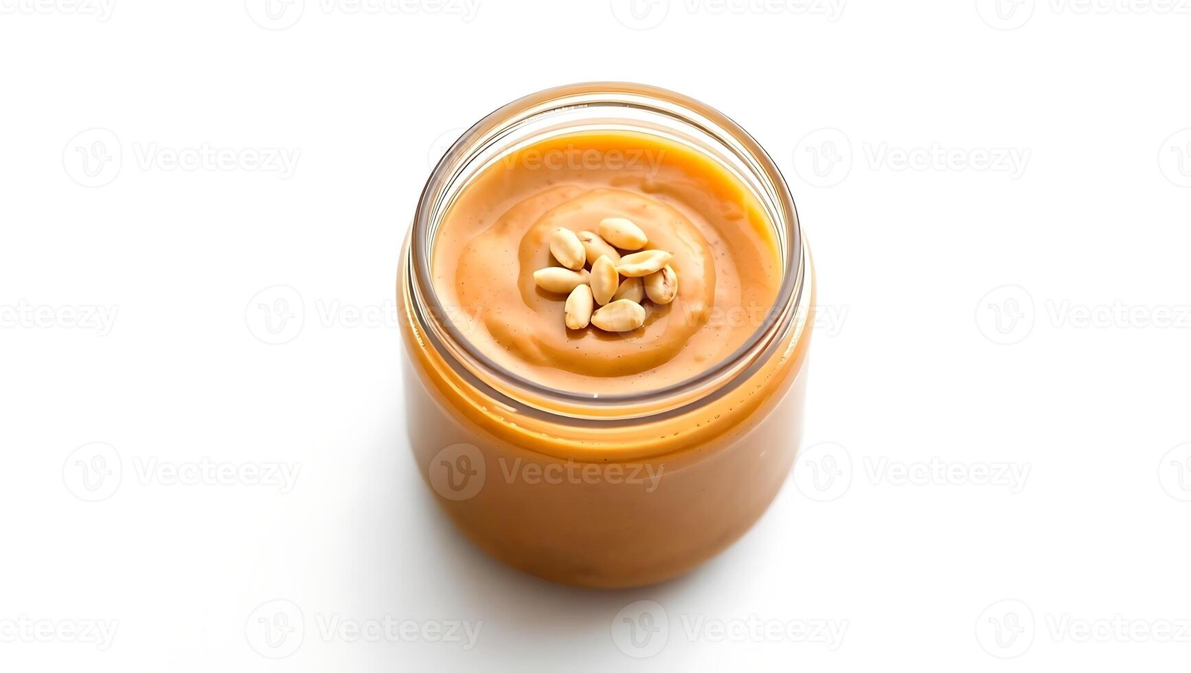 Creamy peanut butter in a jar with roasted peanuts on top photo