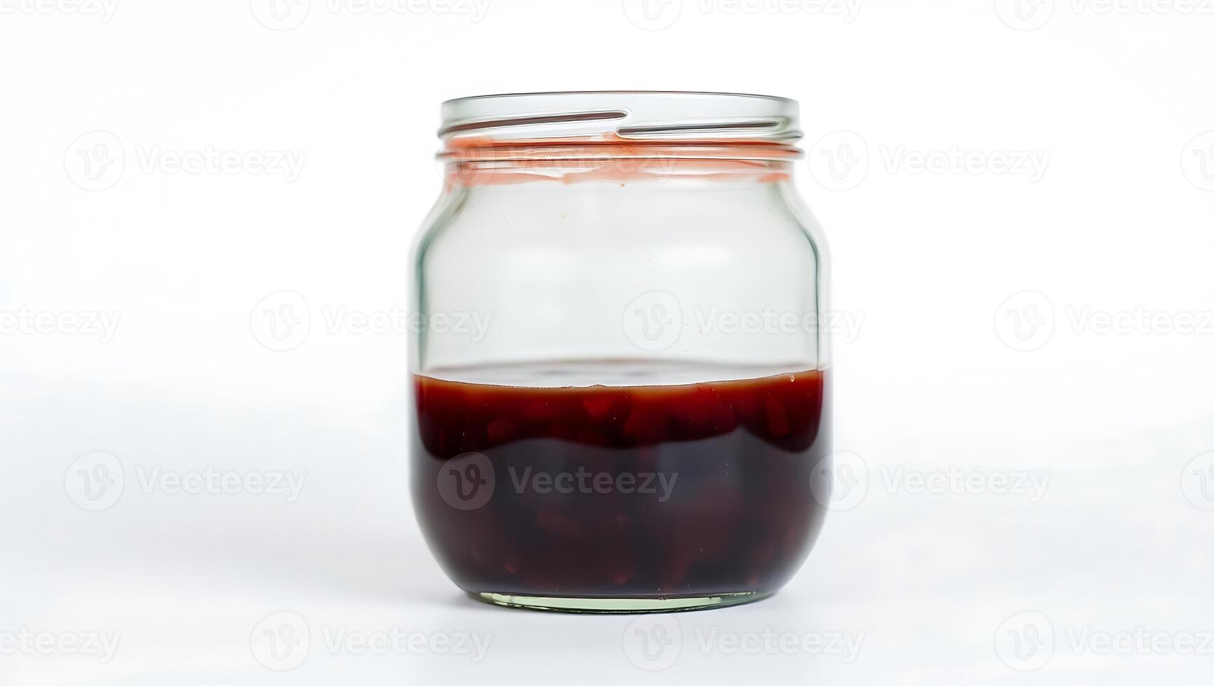 Dark syrup in a clear jar on a plain surface photo