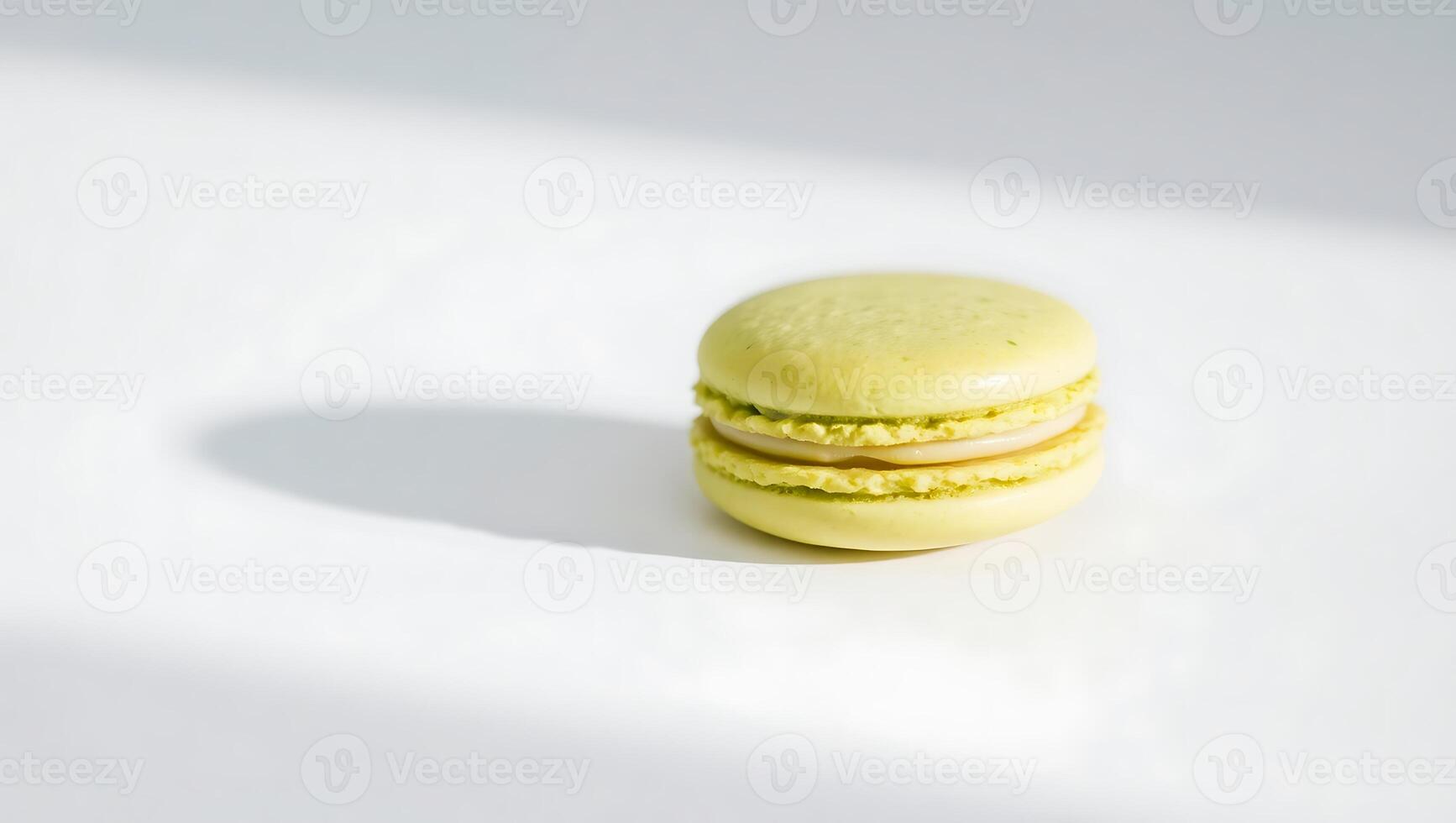 Green macaron on a white surface with soft shadow photo