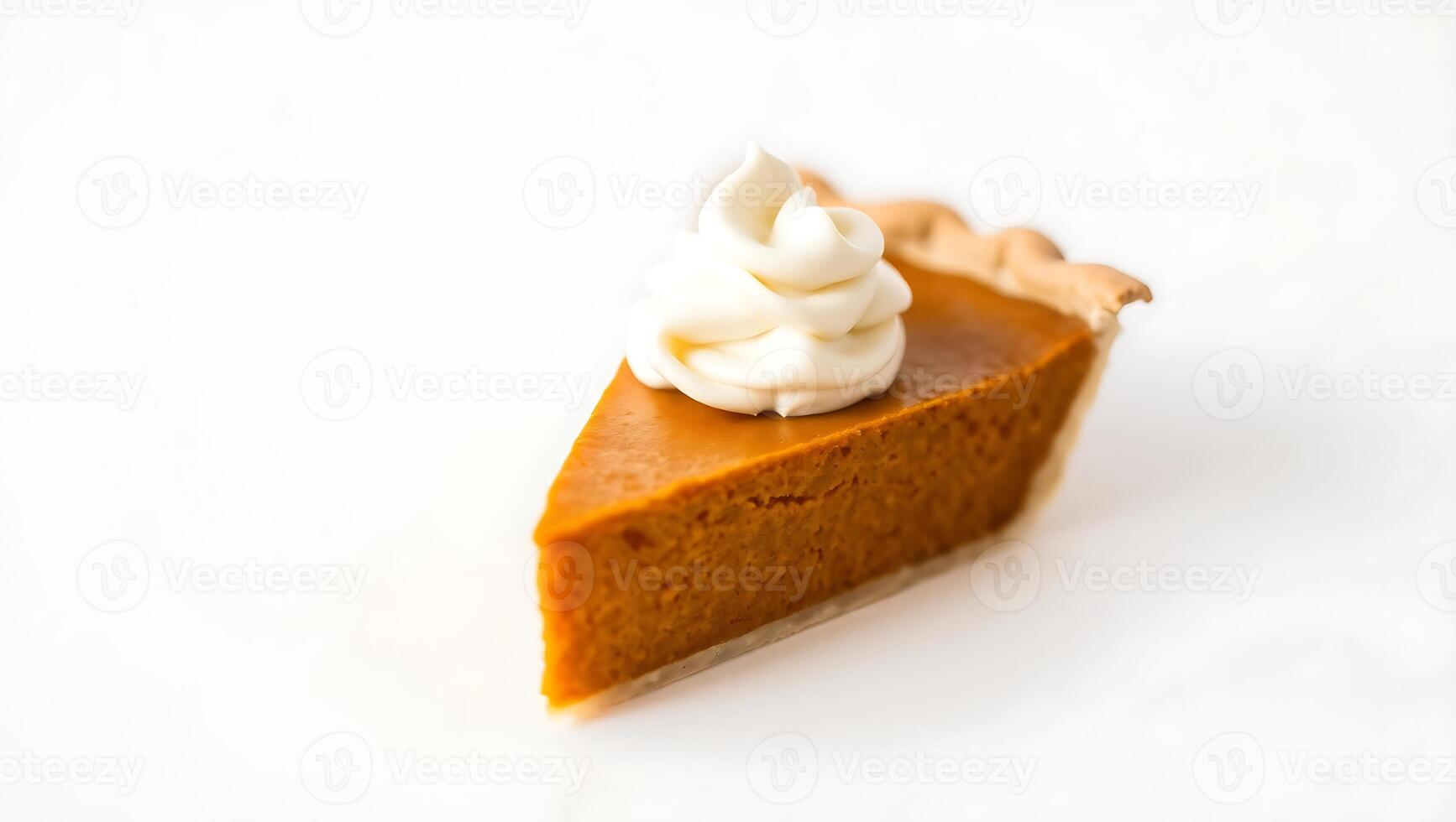 Slice of pumpkin pie topped with whipped cream on a plain surface photo