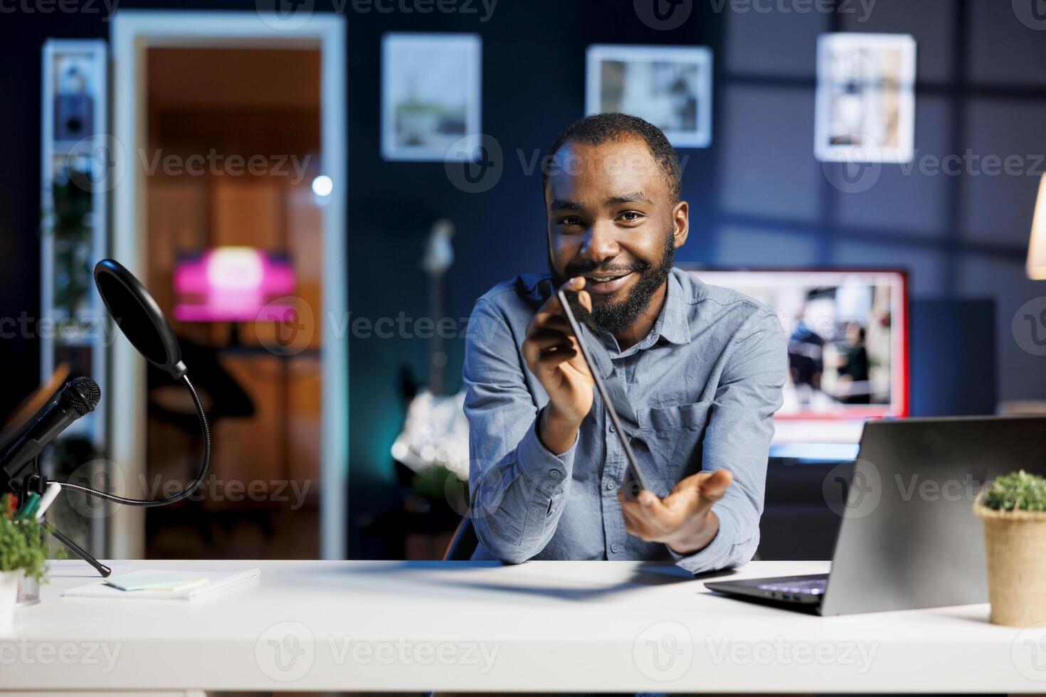 Internet show host being sponsored by partnering brand to do gaming tablet unboxing content. Tech specialist does influencer marketing, doing digital device product placement photo