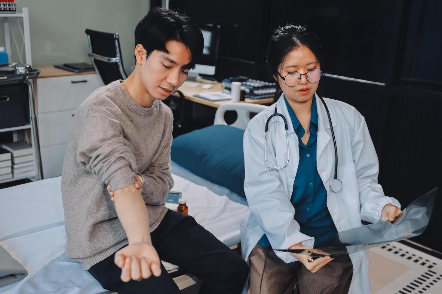 A doctor and patient in a hospital room photo