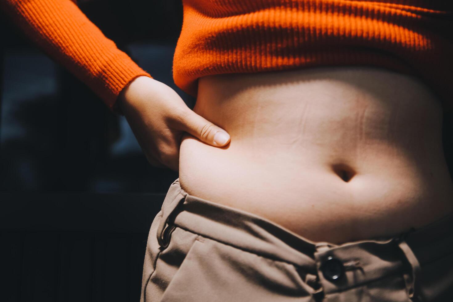 A woman with her stomach showing photo