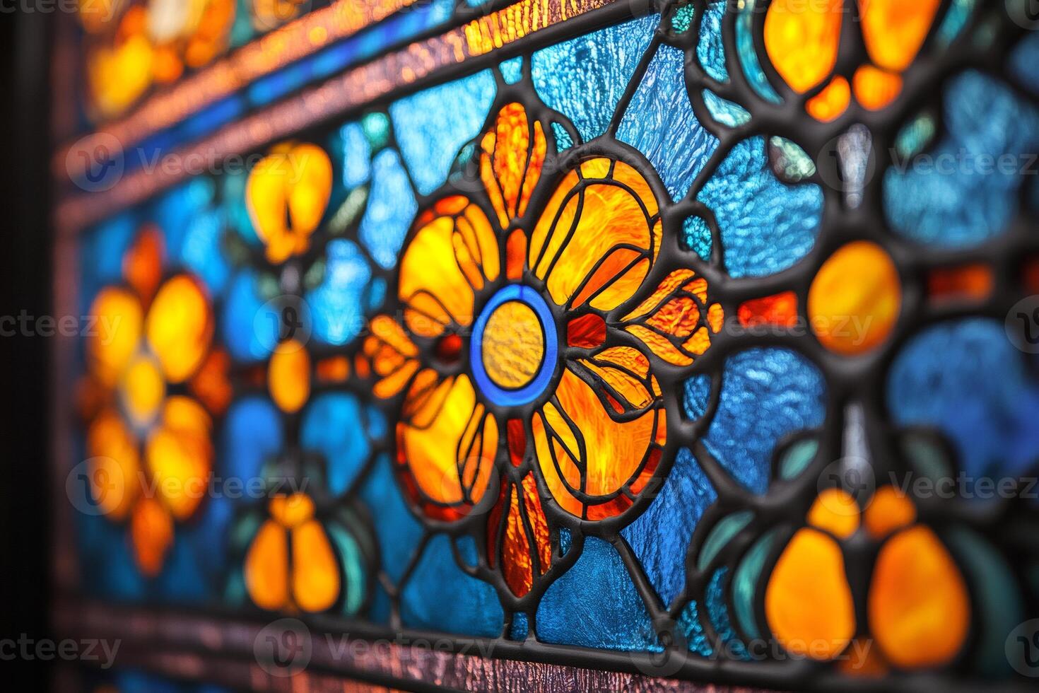 Close up of orange flower on stained glass window illuminating colorful pattern photo