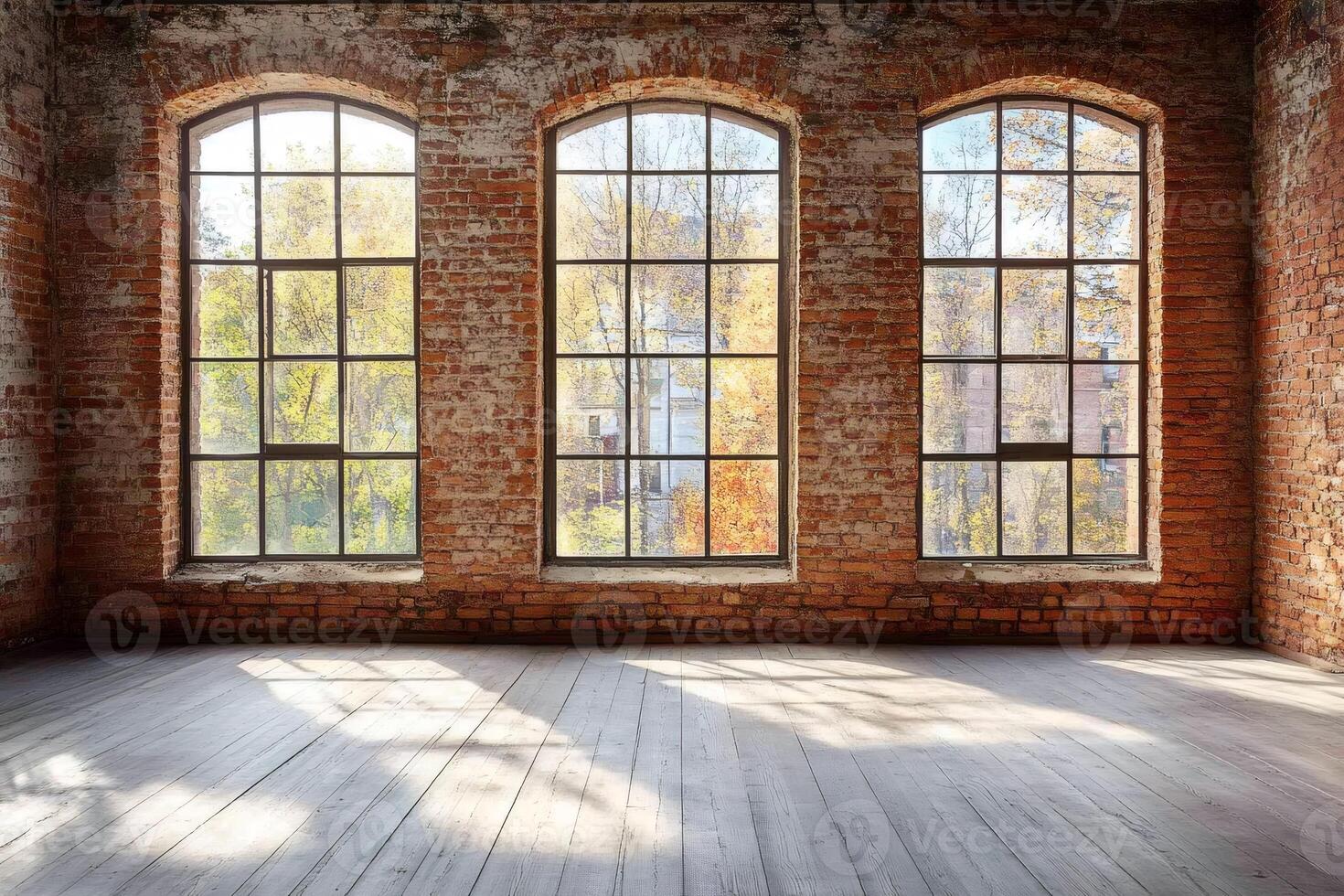 Sunlight illuminating empty room with large windows and brick walls photo