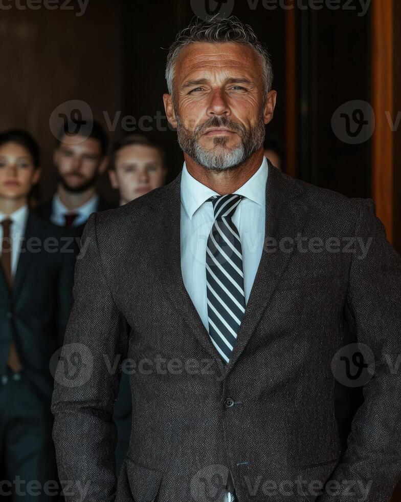 Confident businessman with his team in the background photo