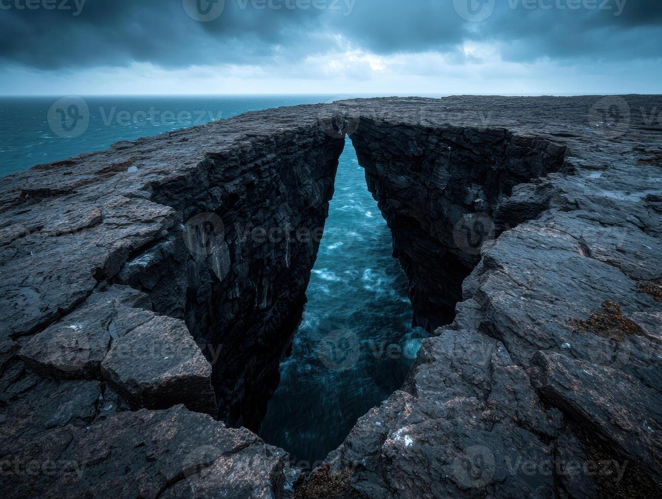 Dramatic coastal landscape with a natural arch and stormy sky photo