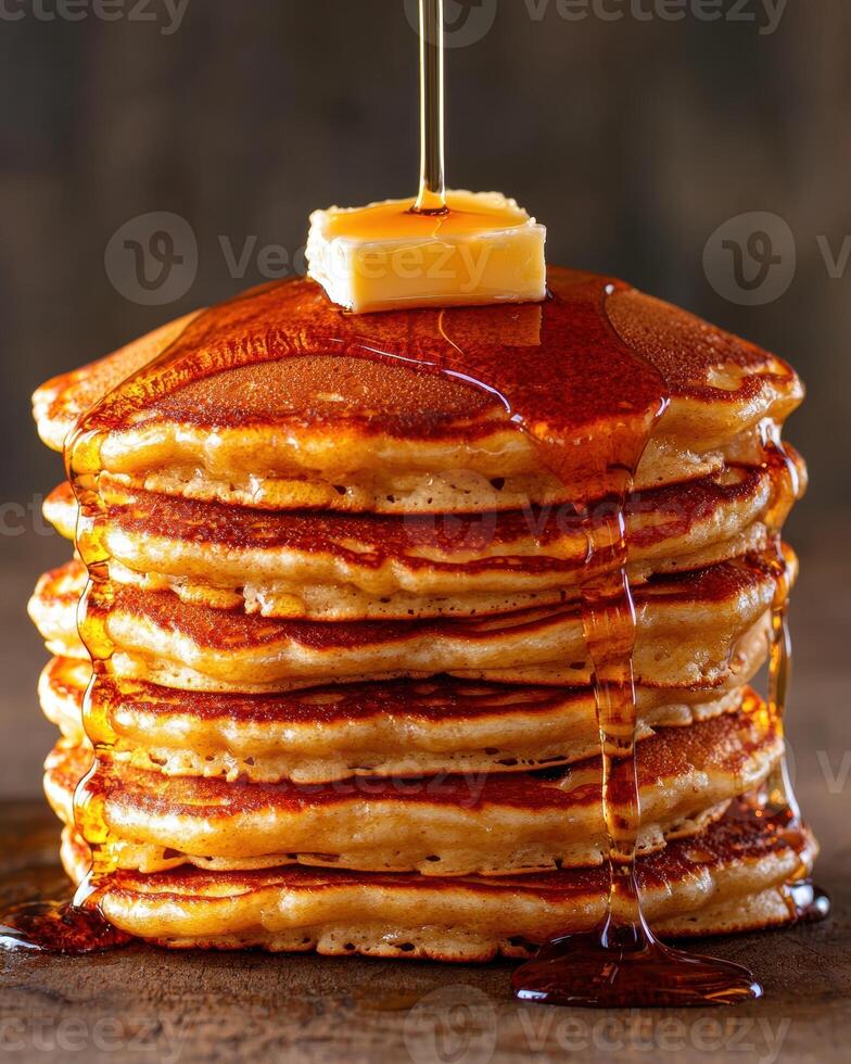 A stack of pancakes with butter and syrup photo