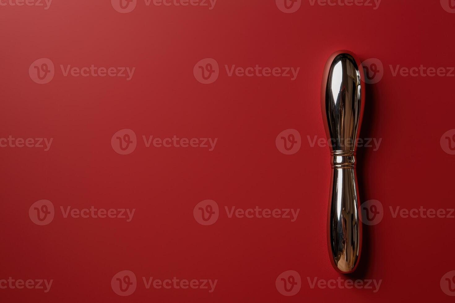 Elegant gold butter knife on a red background photo