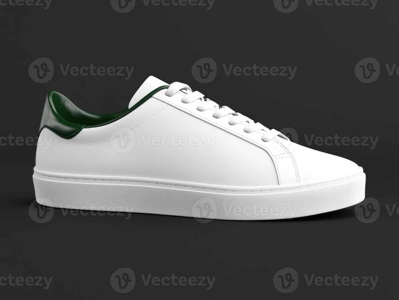 A white leather sneaker with green accents on a dark background photo