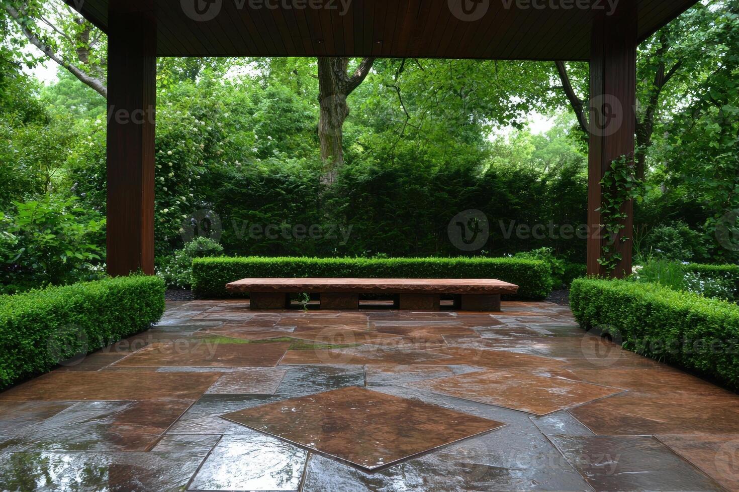 A tranquil outdoor patio with a stone bench surrounded by lush greenery photo