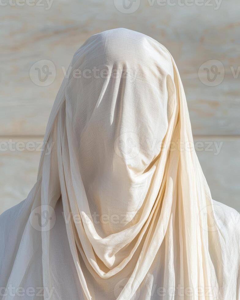 Figure draped in white fabric, faceless and mysterious photo