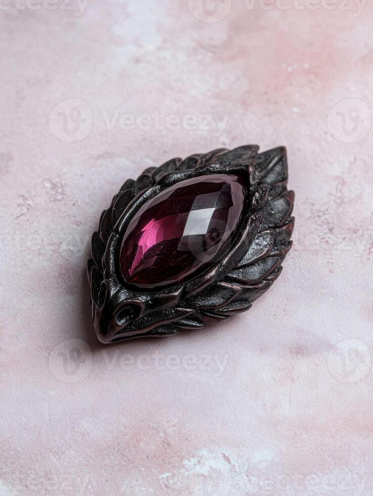 An ornate brooch with a large purple gemstone photo