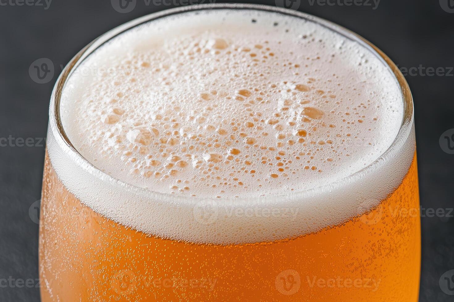 Close up of a glass of beer with foam photo