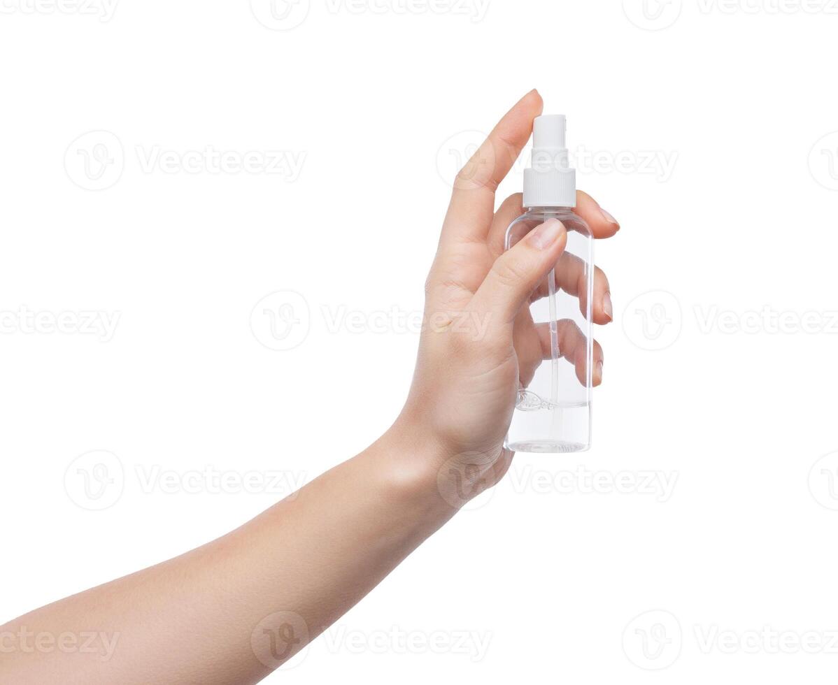 Woman hand holding cosmetics bottle isolated on white background photo
