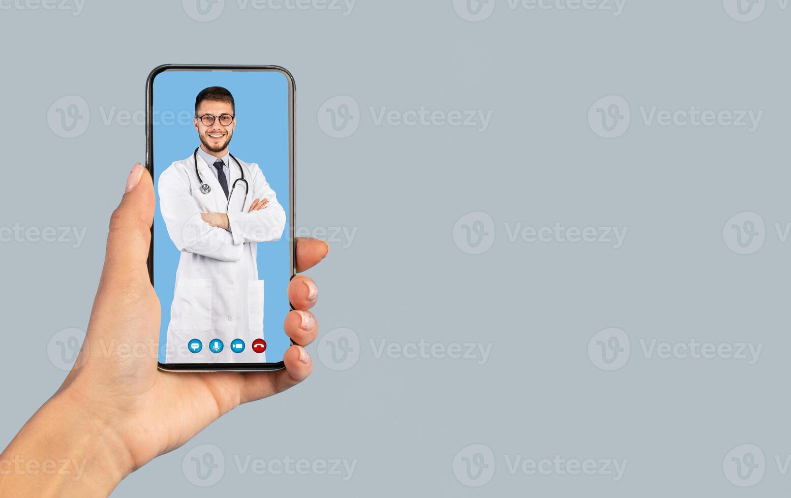 Medical Application. Female Hand Holding Smartphone With Male Doctor On Phone Screen Smiling To Camera Wearing White Uniform On Blue Studio Background. Distance Consultation. Vertical, Collage photo