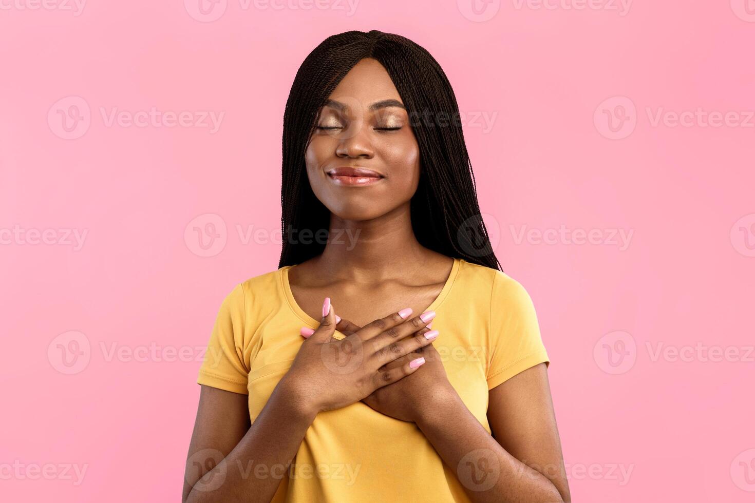 Kindness And Gratitude. Grateful African American Woman Pressing Hands To Chest Posing Smiling With Eyes Closed Over Blue Background. Studio Portrait Of Kind Black Millennial Lady photo