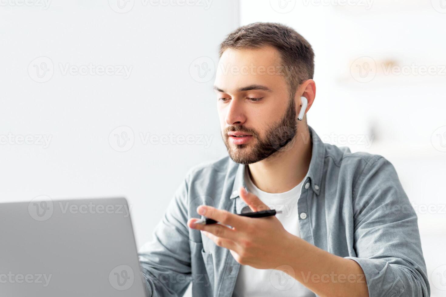 Learning English online. Focused male teacher giving foreign language lesson on web using laptop. Millennial tutor explaining grammar rules to students on internet during covid lockdown photo