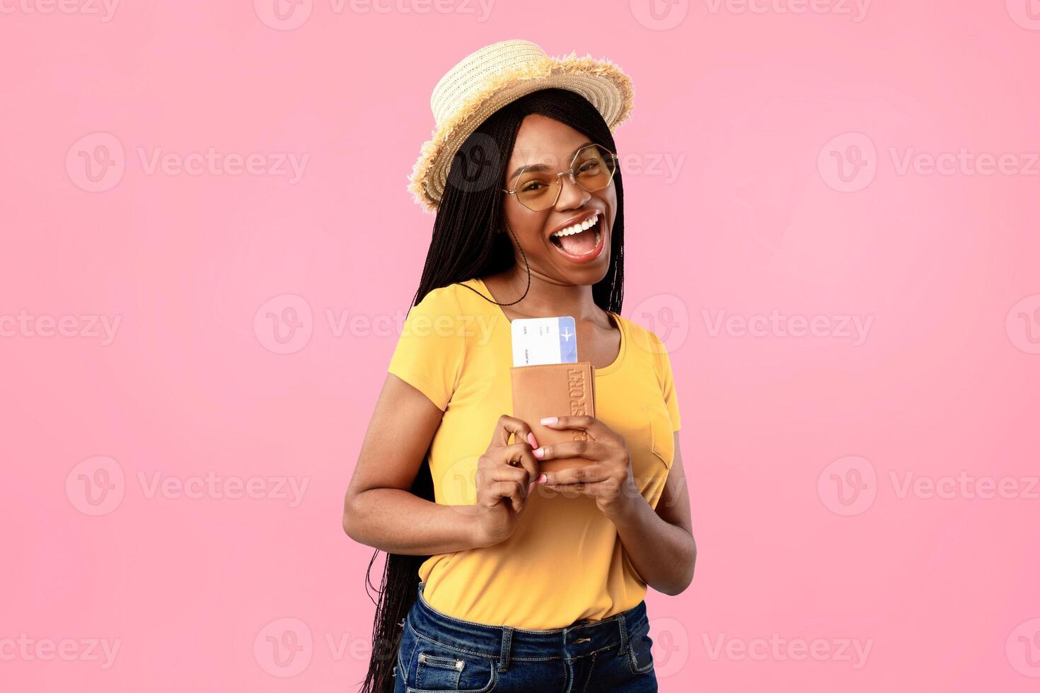 Vacation, Finally. Joyful African American Lady Holding Travel Tickets Smiling To Camera Posing Wearing Hat And Sunglasses On Blue Background. Portrait Of Happy Female Tourist With Boarding Pass photo