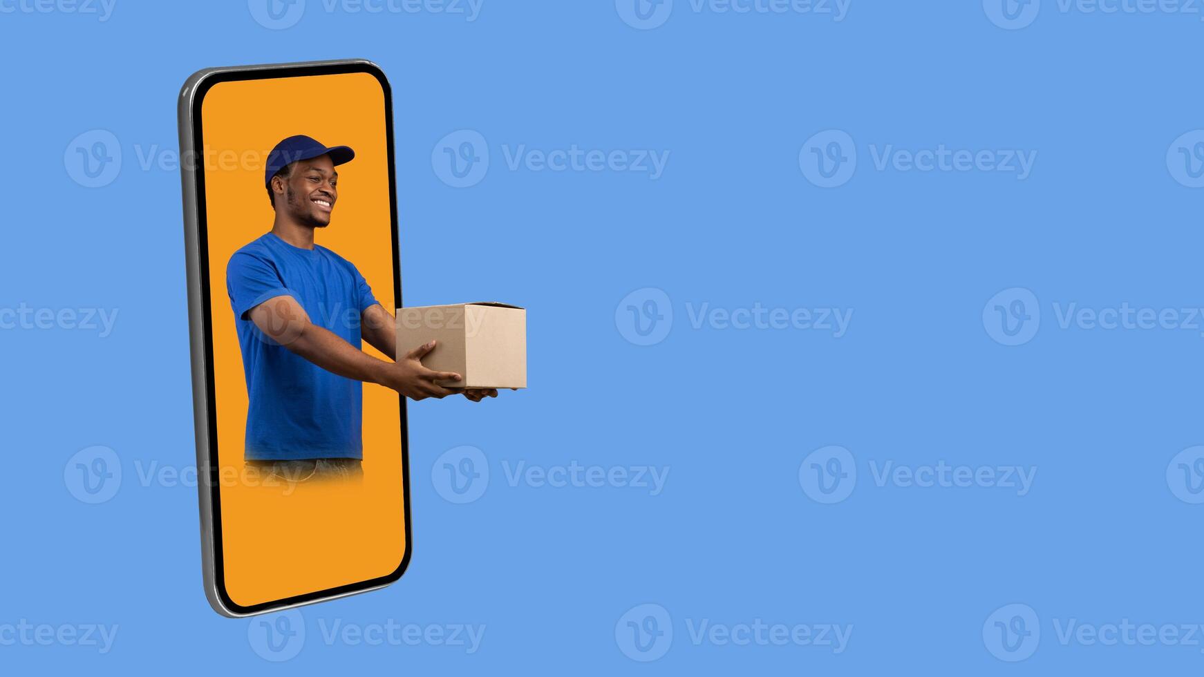 Parcel Shipping App. Black Deliveryman In Phone Screen Giving Cardboard Box To The Side Delivering Package Over Yellow Studio Background. Collage, Panorama With Free Space For Text photo