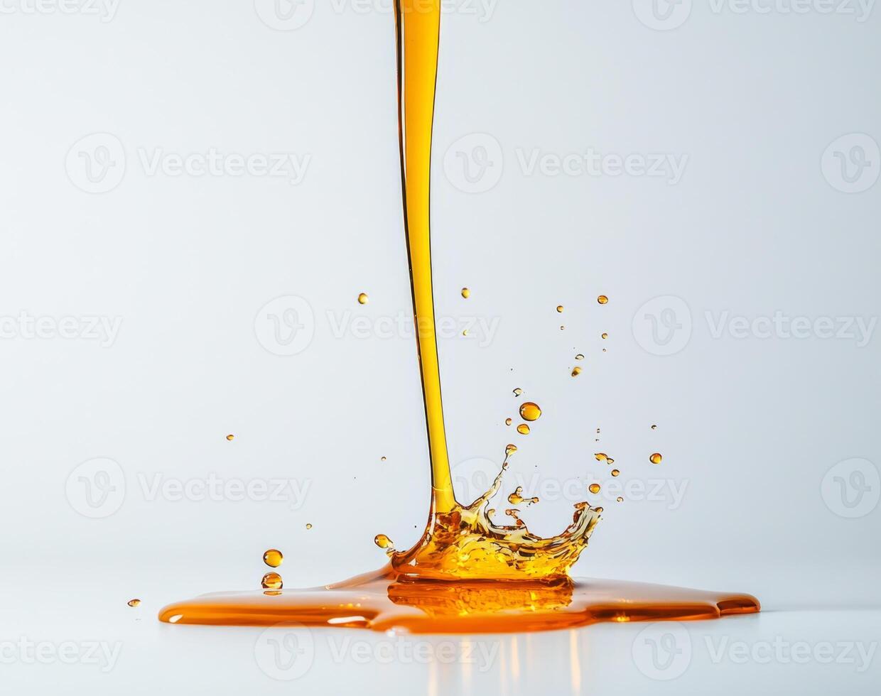 Golden honey cascades in smooth streams, creating splashes as it touches the surface. The rich liquid forms beautiful patterns against a clean white backdrop, showcasing its natural allure. photo