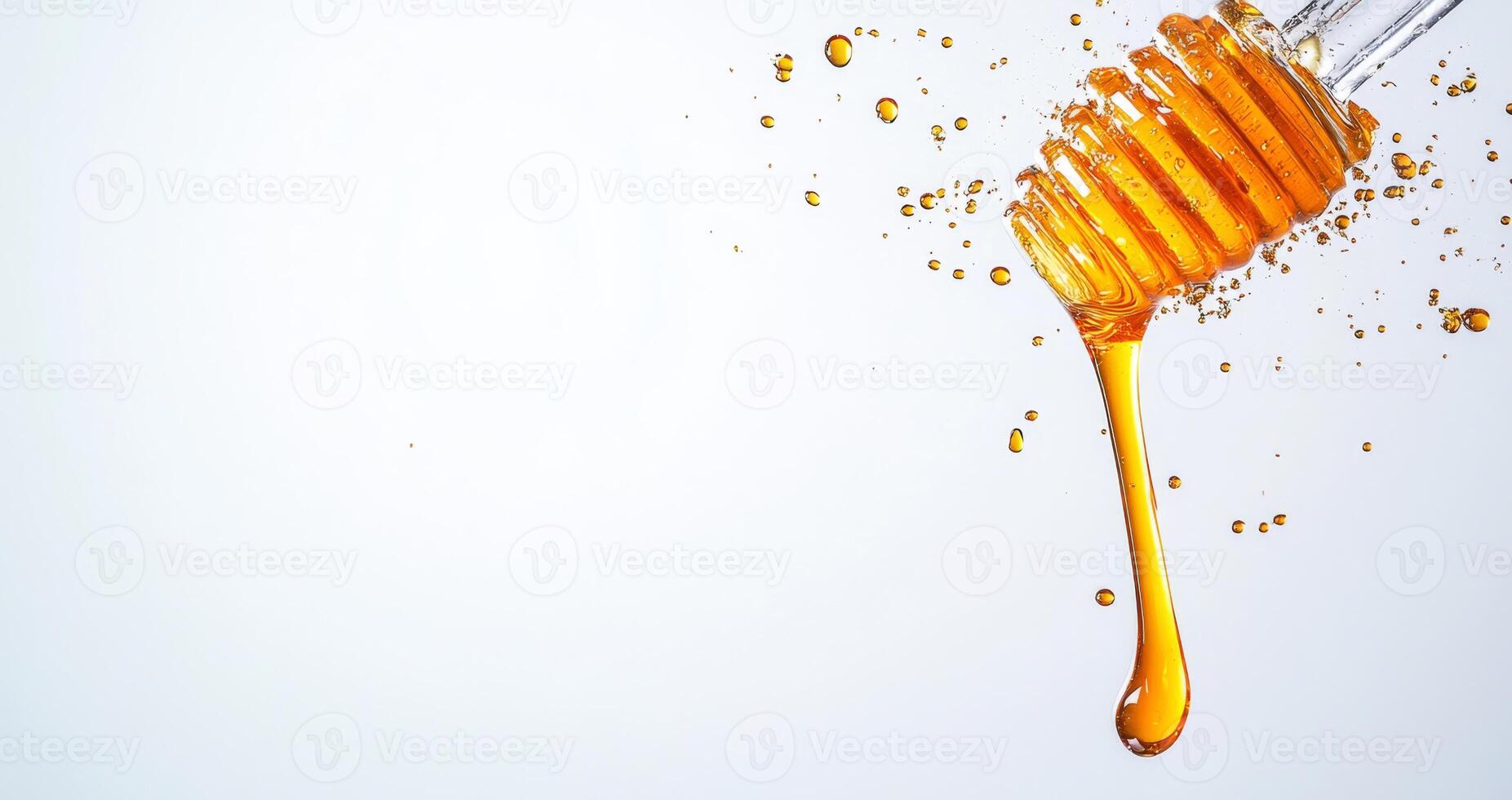 Golden honey drips from a wooden dipper, creating splashes of liquid in the air. The smooth texture and vibrant color contrast beautifully with the light backdrop. photo
