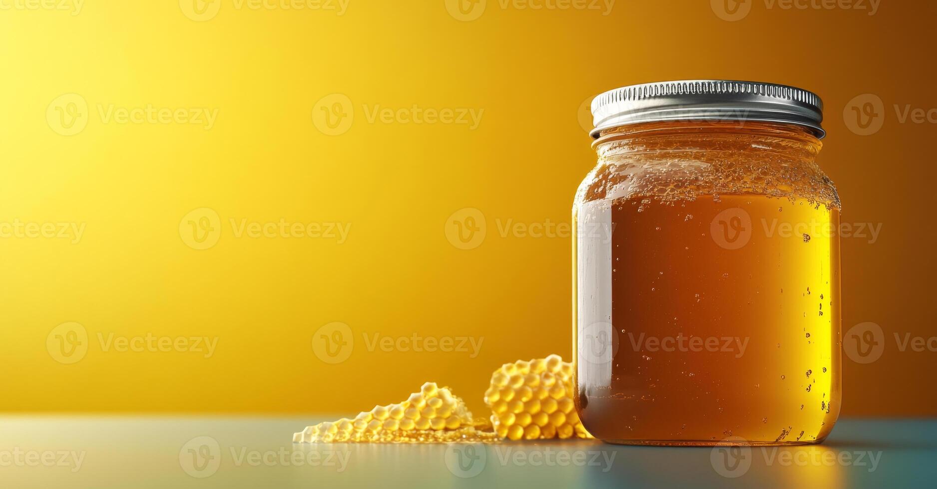A jar of organic honey sits on a surface, with some honeycomb pieces nearby. The warm yellow background enhances the natural appeal, showcasing the rich golden color of the honey. photo